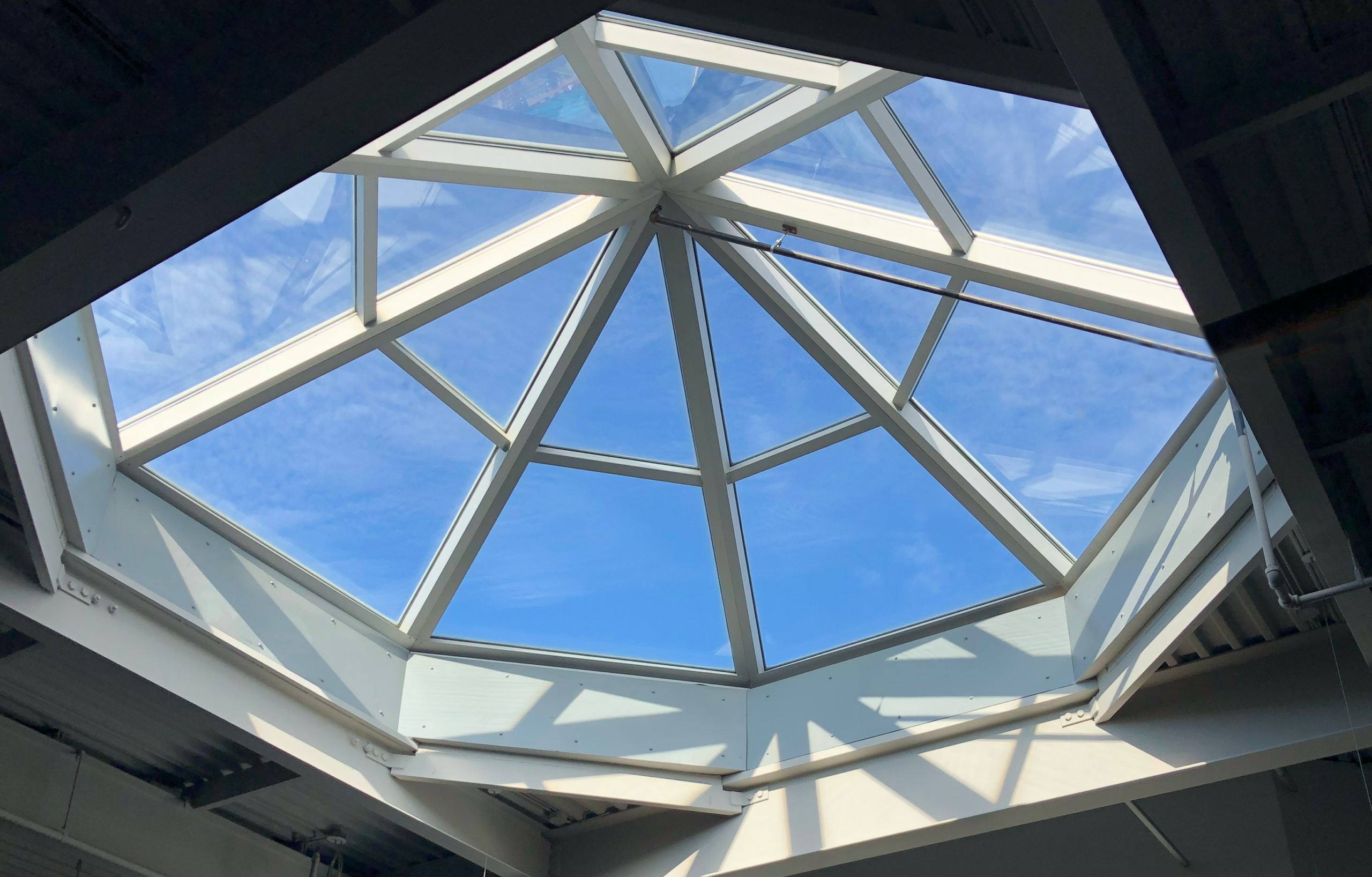 Blue skies through a decorative architectural ceiling